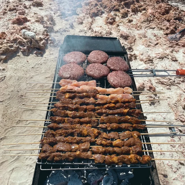 Burgers and skewers on the beach barbecue