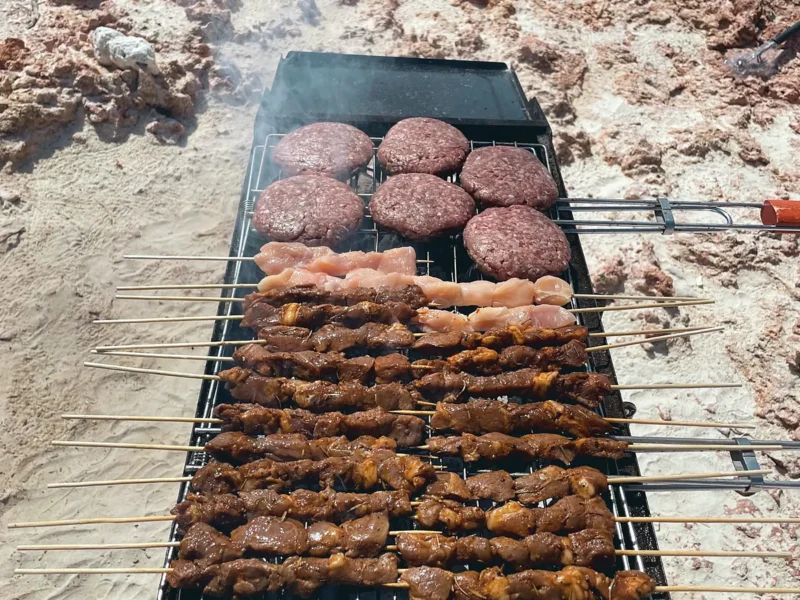 Burgers and skewers on the beach barbecue
