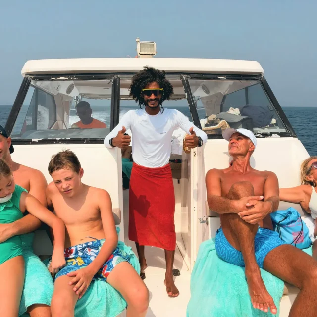 A family relaxing in the sun on the deck of the boat