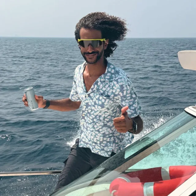 A thumbs-up on the bow of the yacht, open sea behind