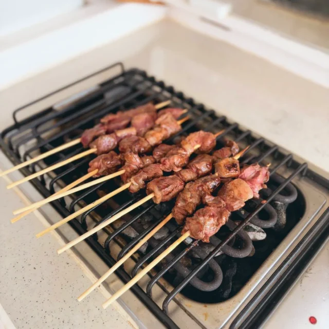 Meat skewers cooking on the yacht grill